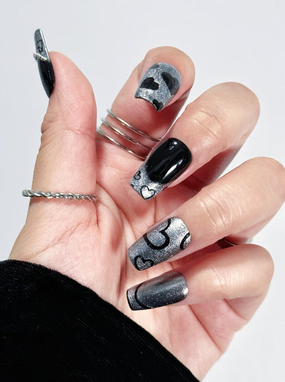 Chic Noir press-on nail fist posture