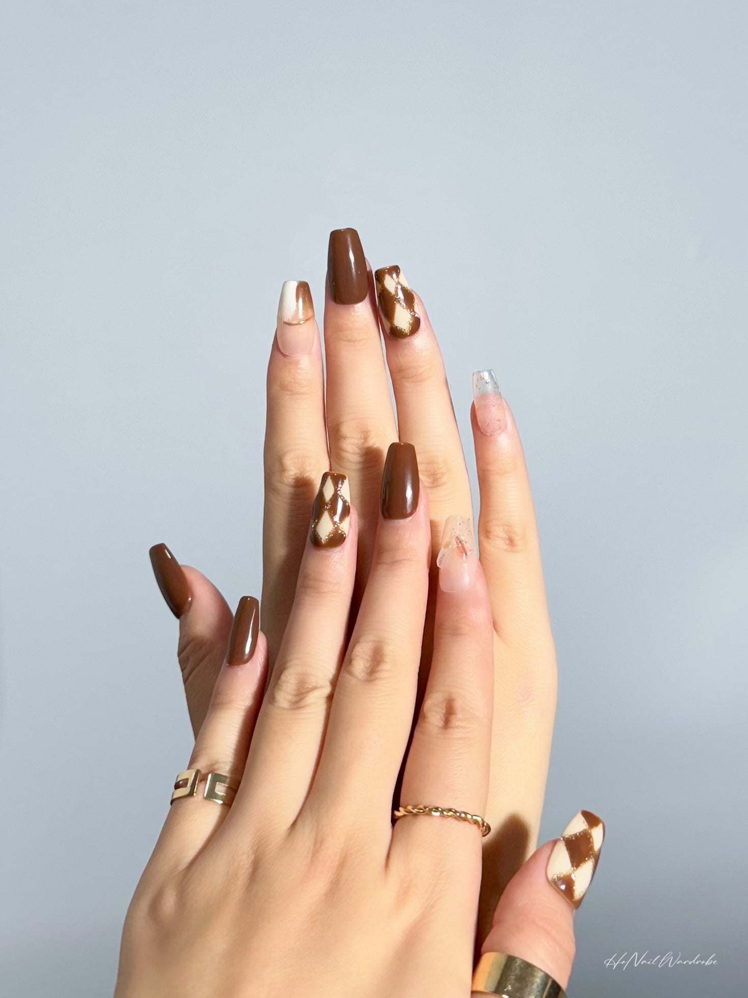 Golden Checkmate Elegance press-on nail two hands together